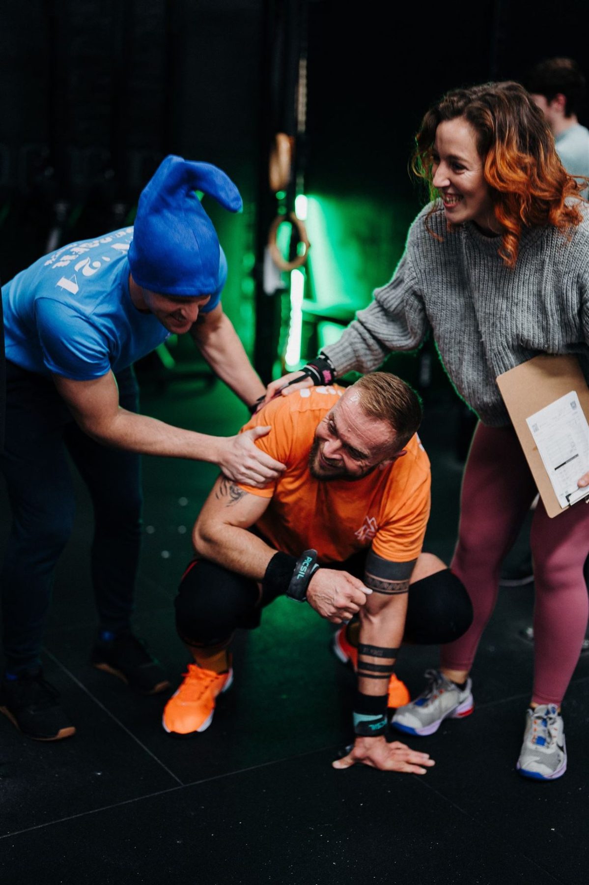 A coach supporting a member during a CrossFit session